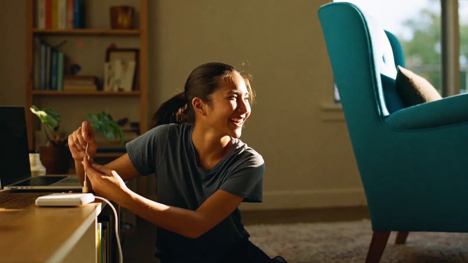 A tech helper connecting a wifi router in a living room, pleased it has come up.