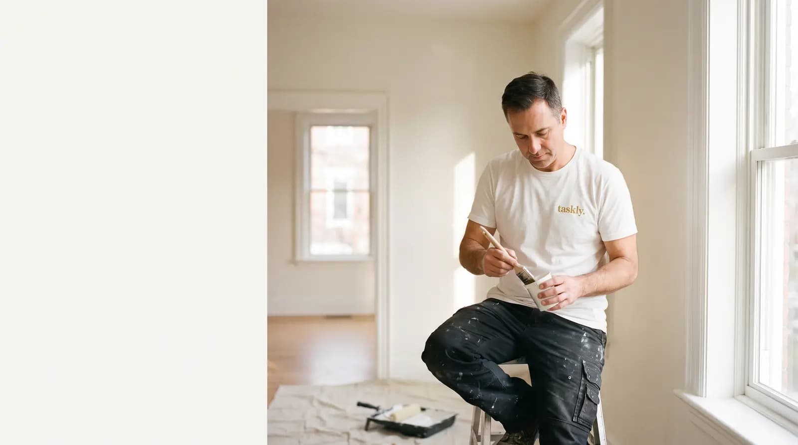 A ceiling line being cut in with an angled brush in a room being repainted in Toronto.