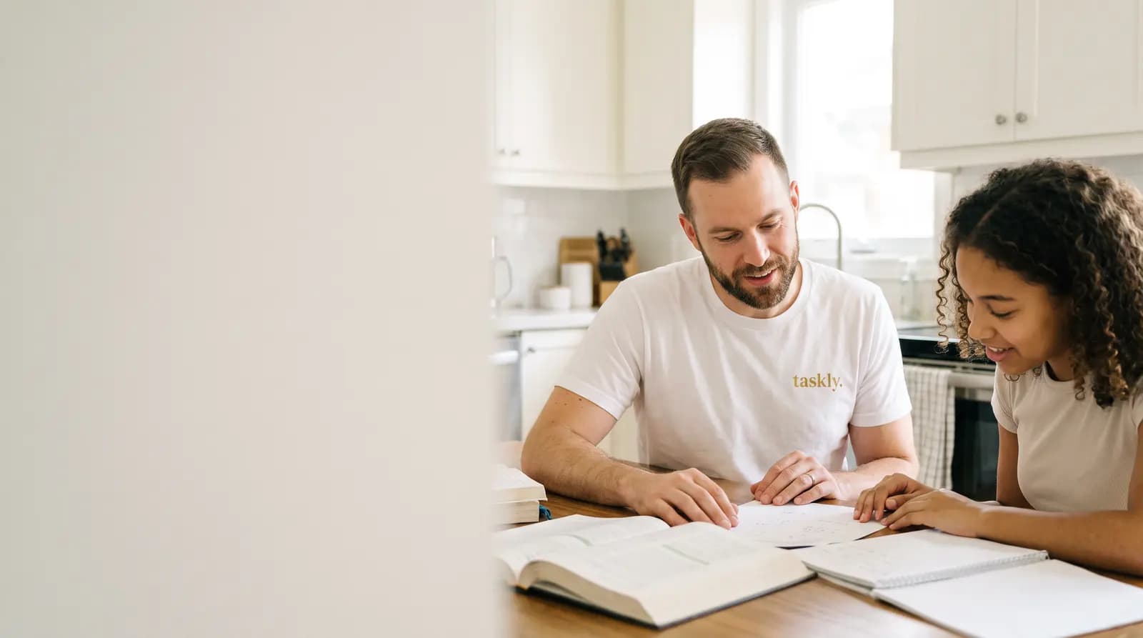 A tutor and a student working through a problem together at a kitchen table in the GTA.